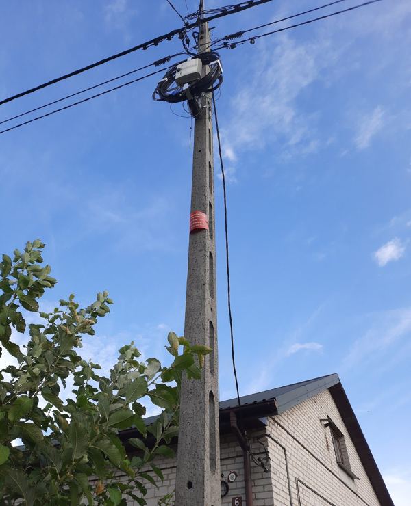 Aerial fiber drop cable running from a utility pole to a house